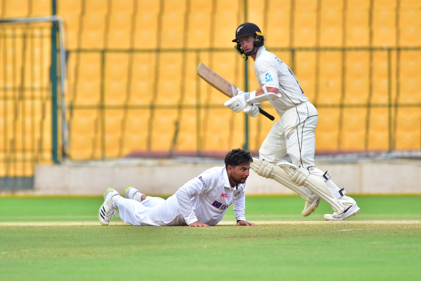 Cam Fletcher works one away as Kuldeep Yadav looks on
