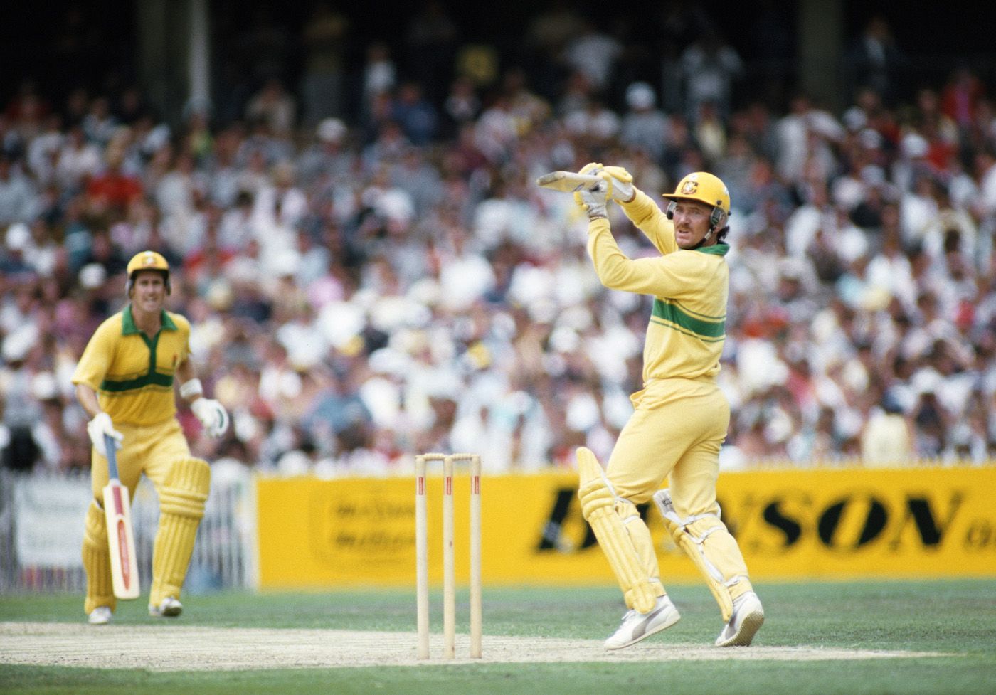Allan Border cuts as Graeme Wood watches