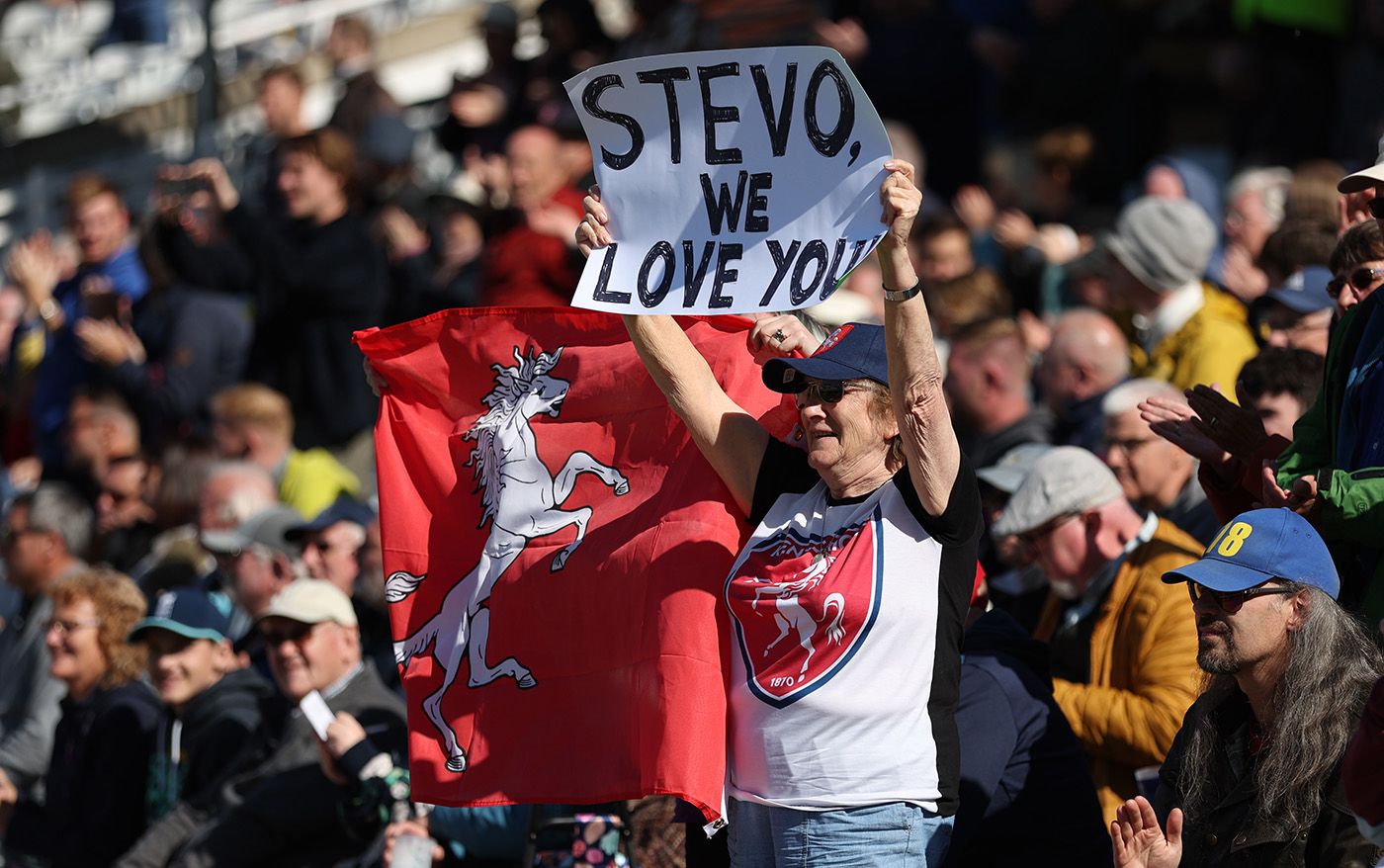 A fan holds up a poster for Darren Stevens