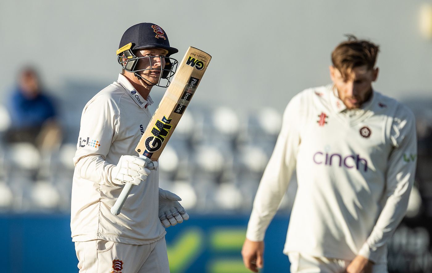 Tom Westley raises his bat on reaching fifty