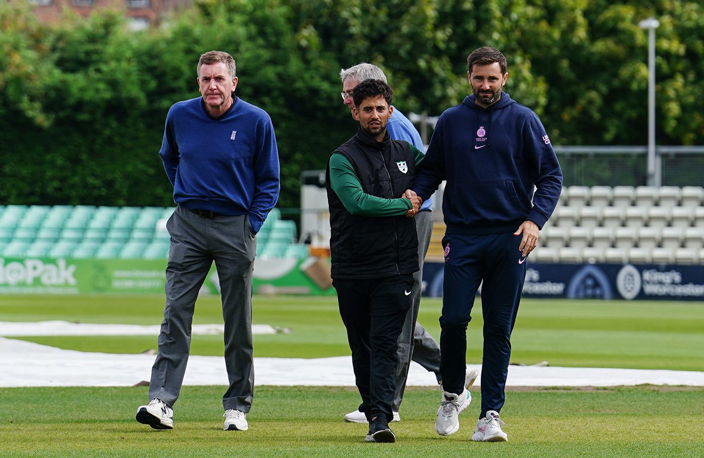 Brett D'Oliveira and Tim Murtagh shake hands after the game was abandoned as a draw
