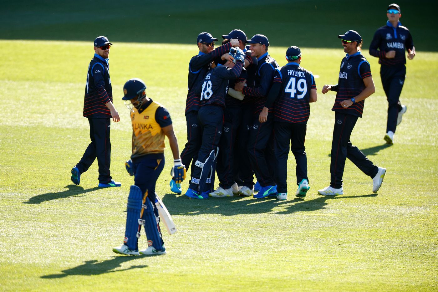 Ben Shikongo is mobbed by team-mates after claiming Danushka Gunathilaka for a golden duck