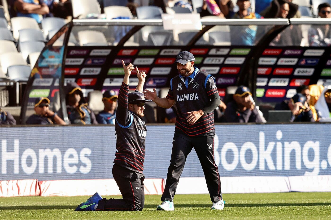 Jan Nicol Loftie-Eaton raises his arms in celebration after completing a running, diving take to dismiss Wanindu Hasaranga