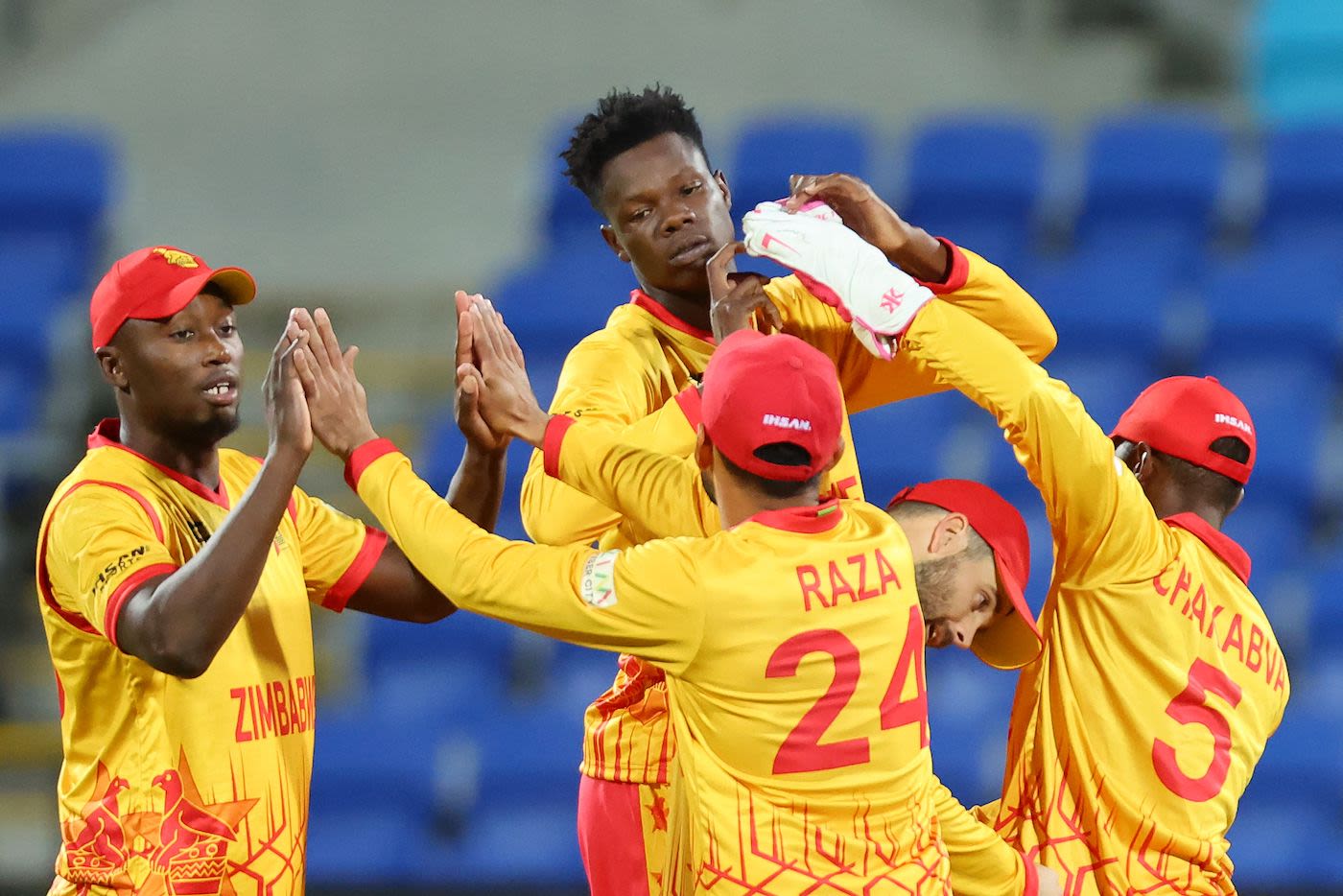 Blessing Muzarabani and Tendai Chatara tag along with team-mates at the end of Ireland's innings