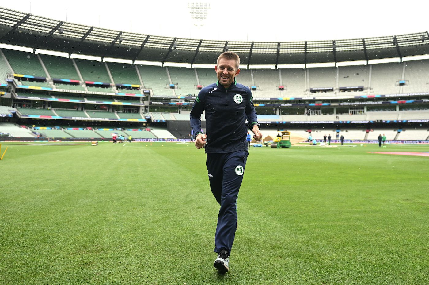 Ireland's coach, Heinrich Malan, takes off as rain approaches