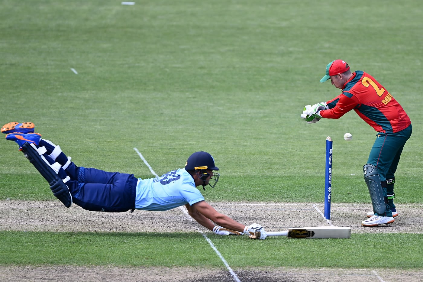 Chris Green dives to avoid being run out by Jake Doran