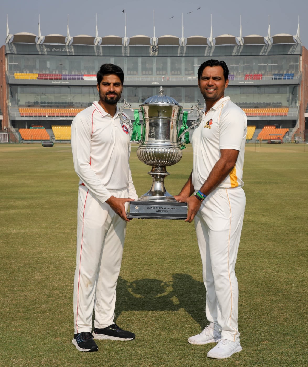 Northern captain Umar Amin and Sindh captain Nauman Ali pose with the trophy ahead of the Quaid-e-Azam Trophy final