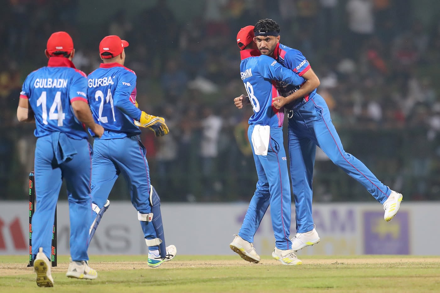 Yamin Ahmadzai is congratulated by his team-mates