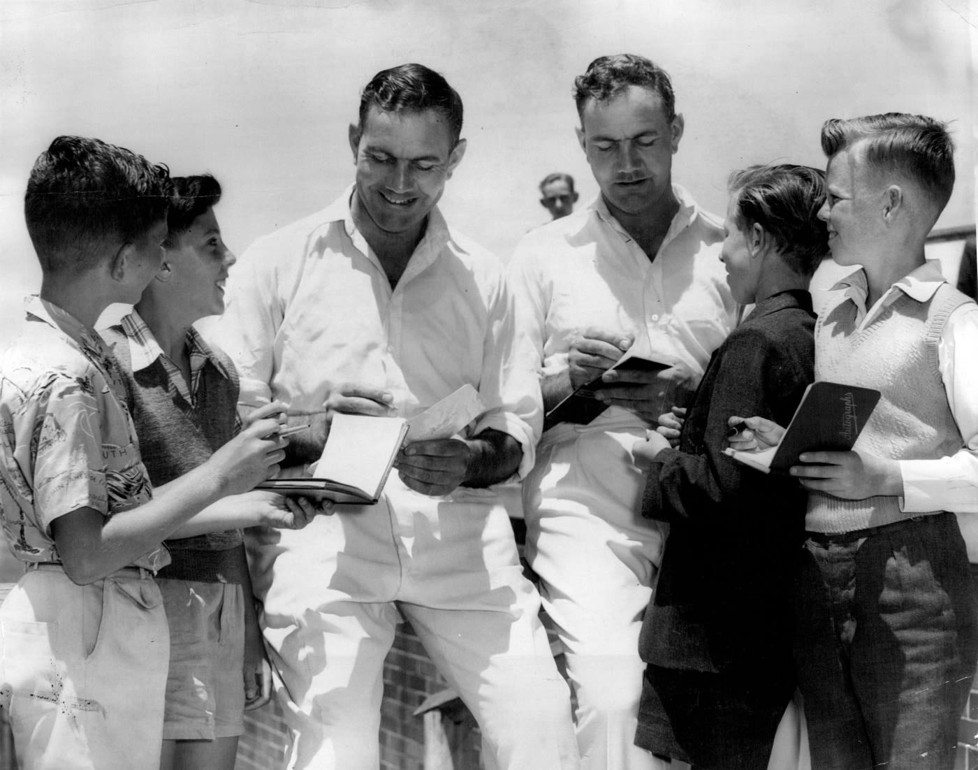 Alec and Eric Bedser oblige their fans with autographs