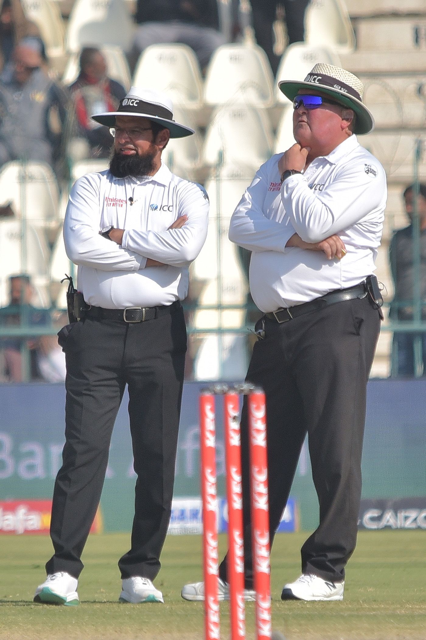 Aleem Dar and Marais Erasmus wait for third umpire Joel Wilson's decision