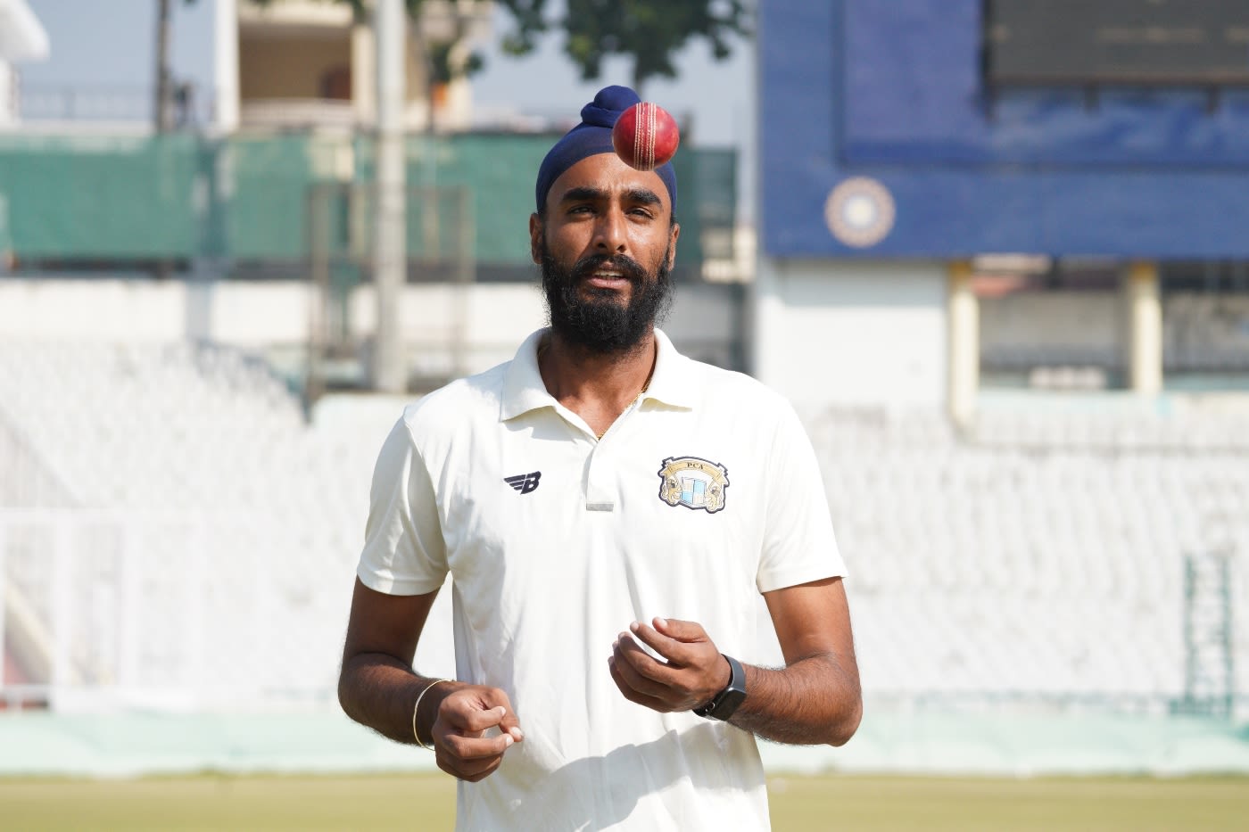 Baltej Singh tosses the ball