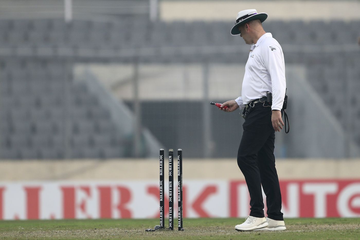 Umpire Chris Brown brings out the light meter