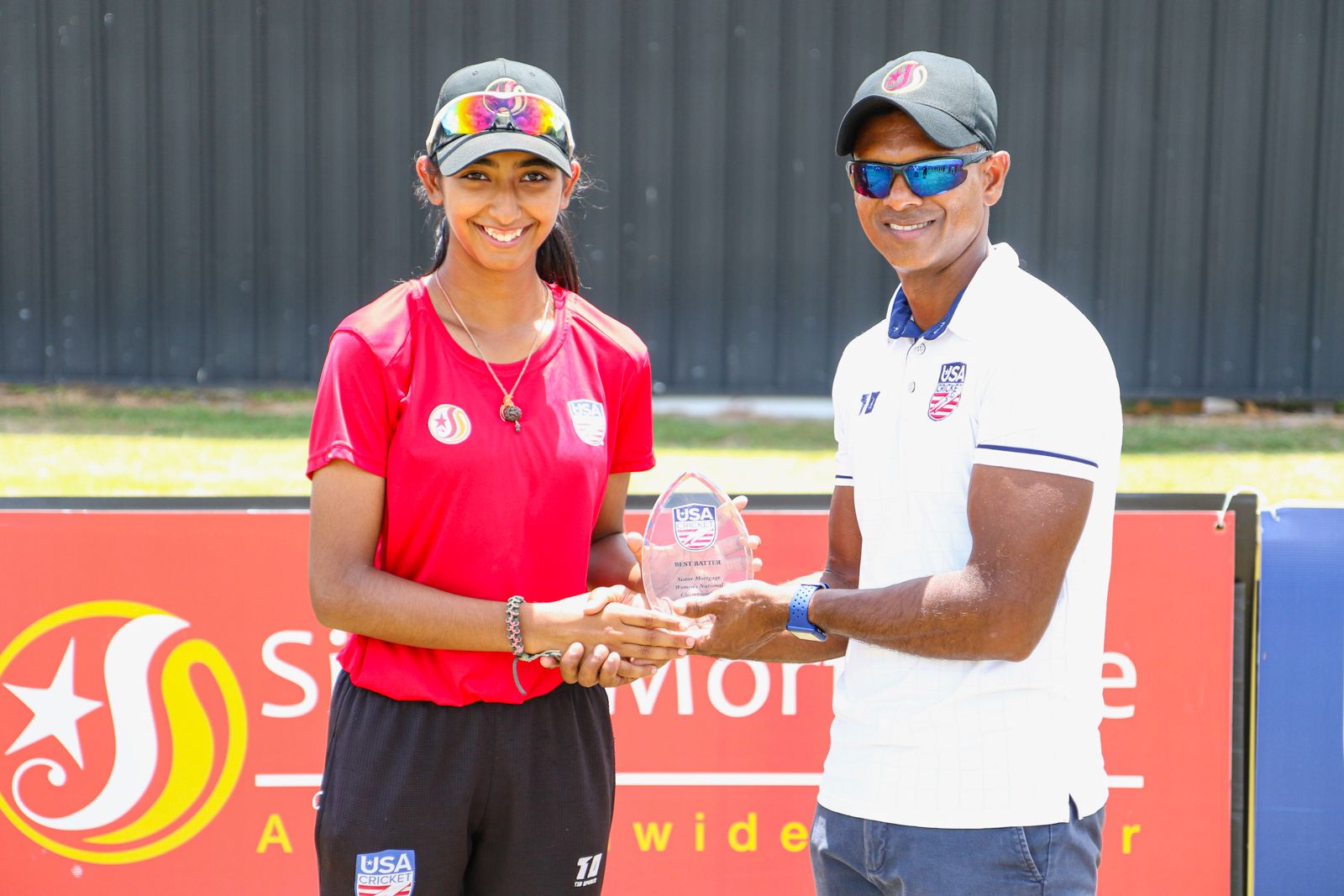 Aditi Chudasama receives the Best Batter Award at the 2022 USA Cricket Women's National Championship from USA Women's head coach Shivnarine Chanderpaul