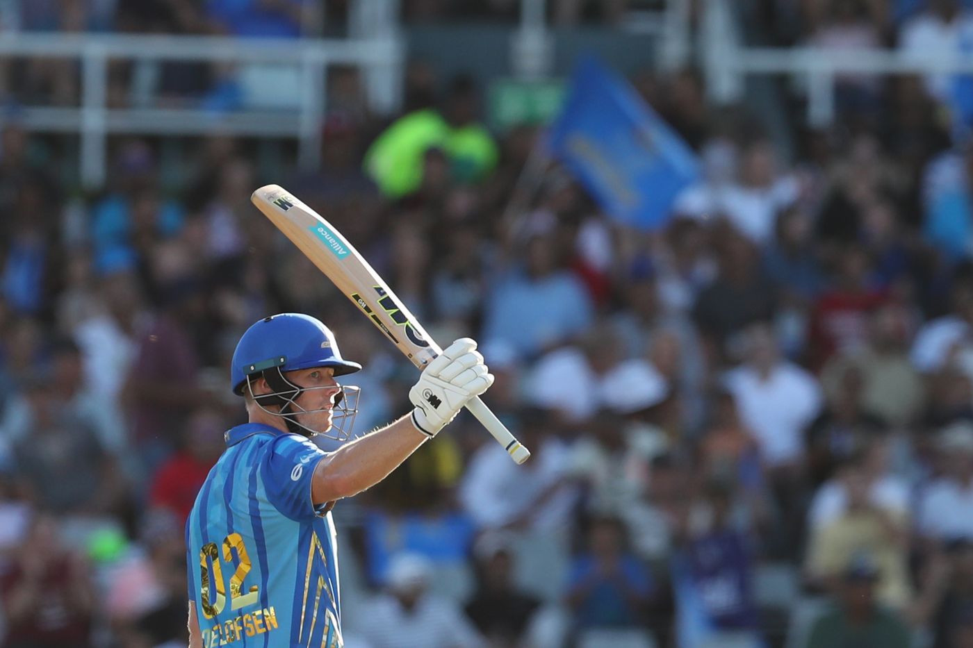 Grant Roelofsen raises his bat on getting to a fifty