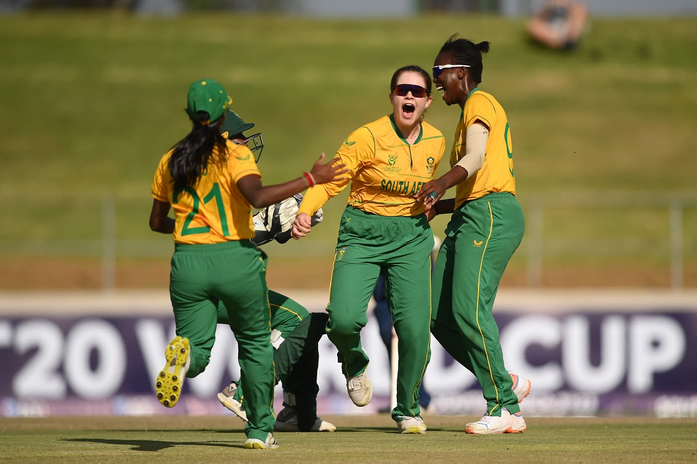 Legspinning allrounder Madison Landsman celebrates with Seshnie Naidu and Oluhle Siyo
