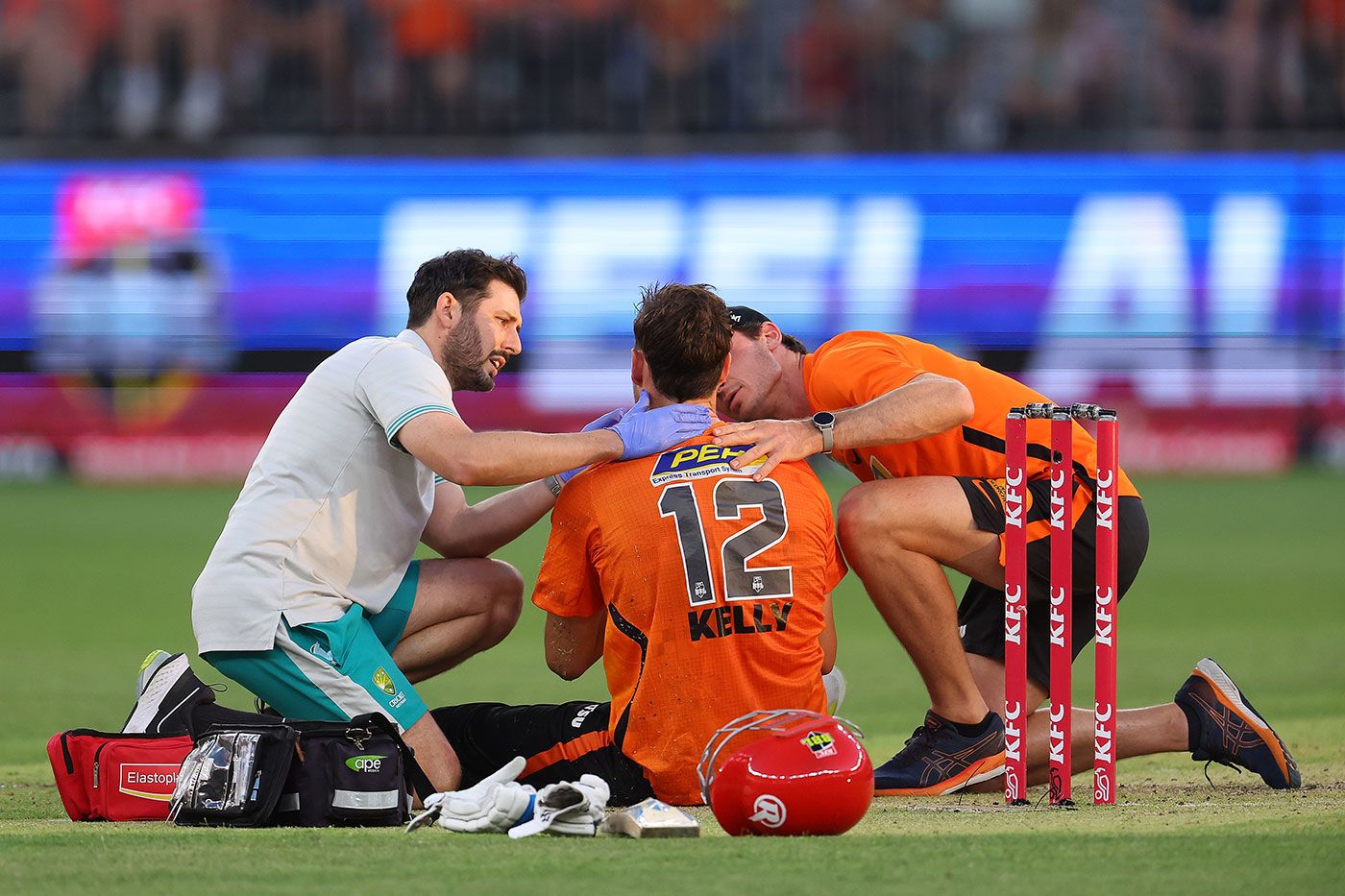Matt Kelly is helped by medical staff after a blow in the face