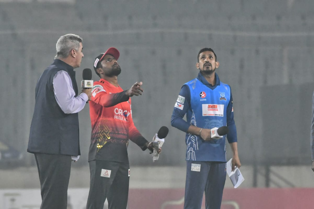 Imrul Kayes flips the coin as Nasir Hossain looks on
