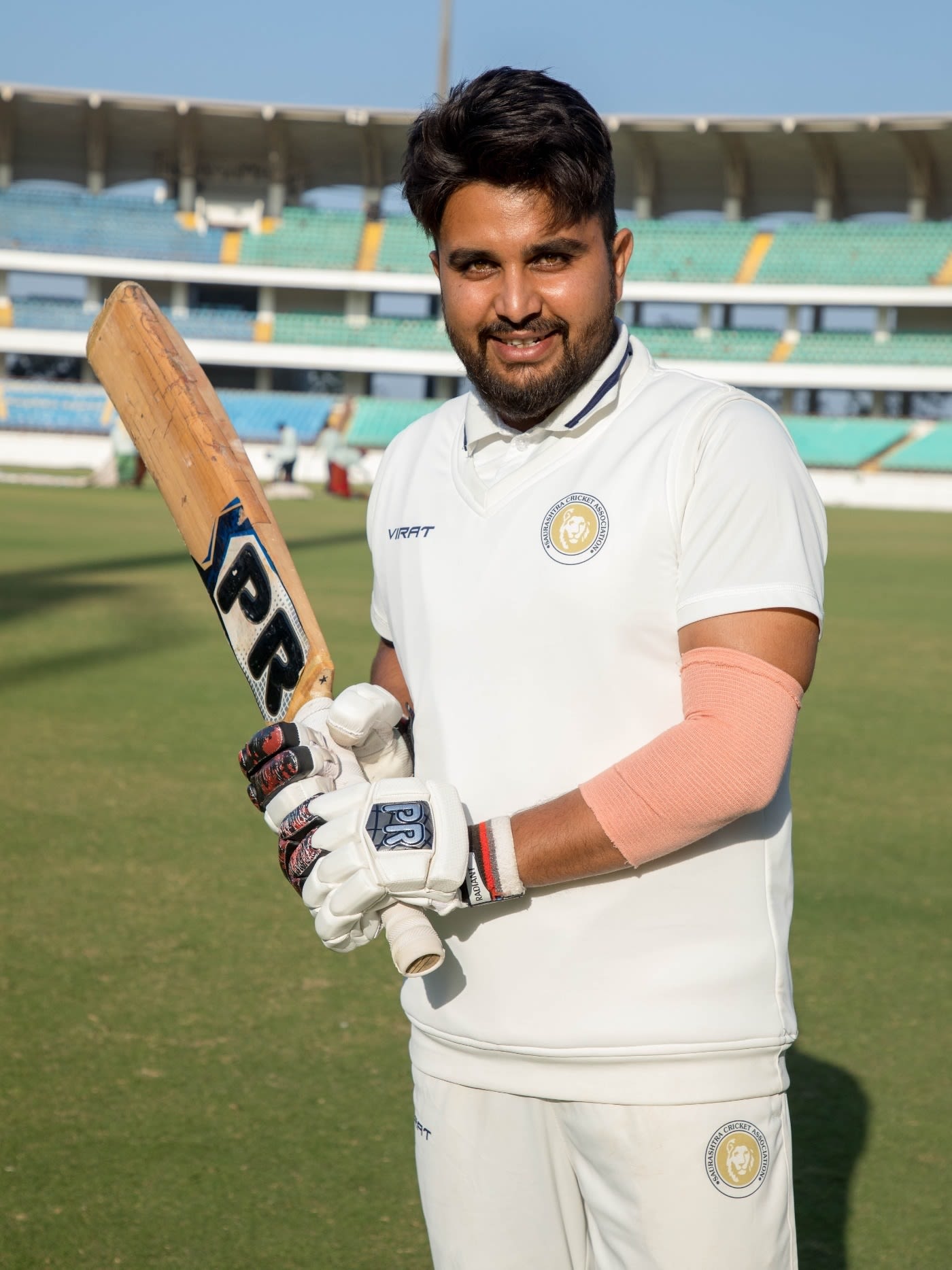 Snell Patel poses after his well-made 70 against Punjab