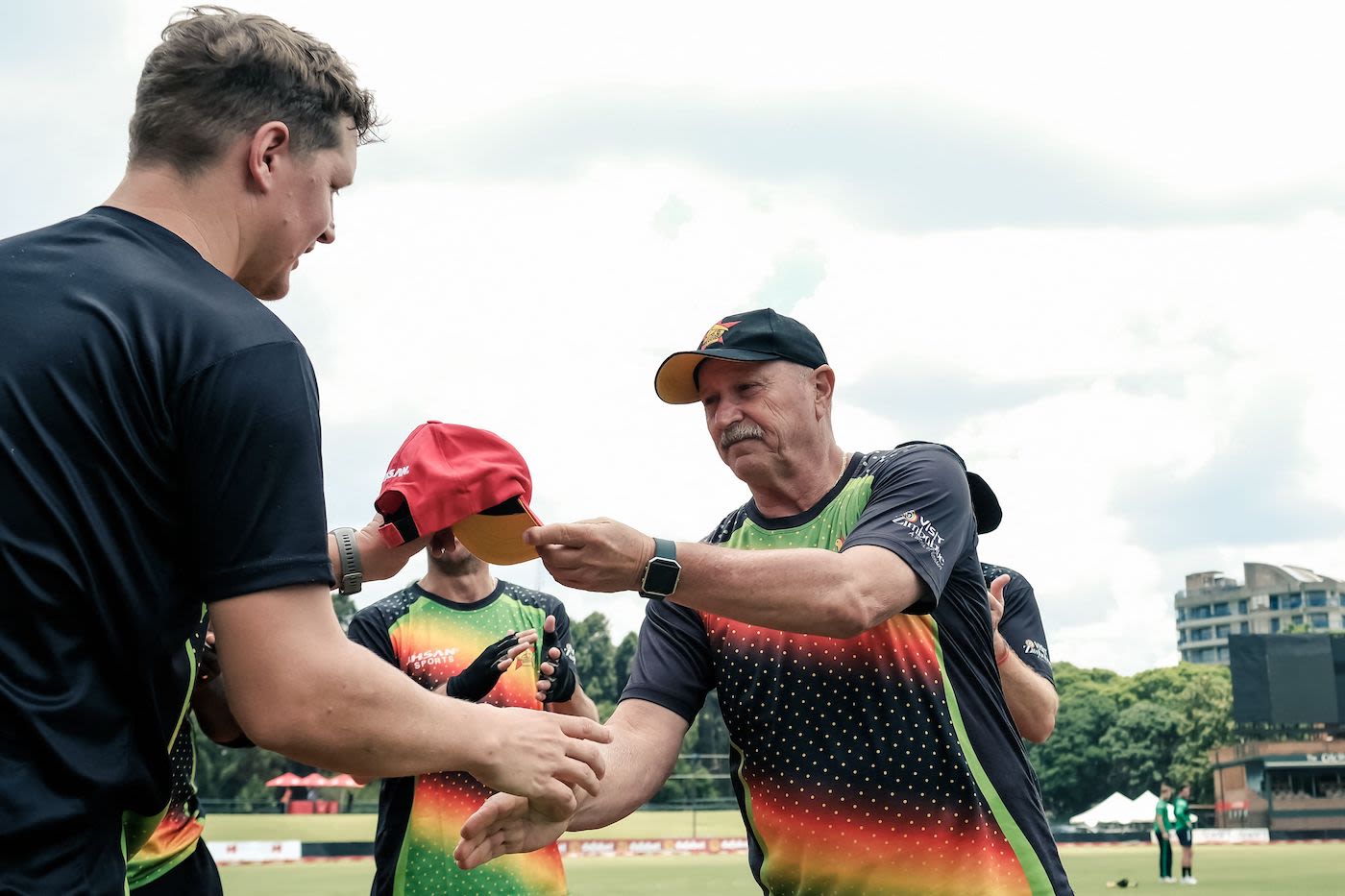Gary Ballance receives his Zimbabwe T20I cap from Dave Houghton