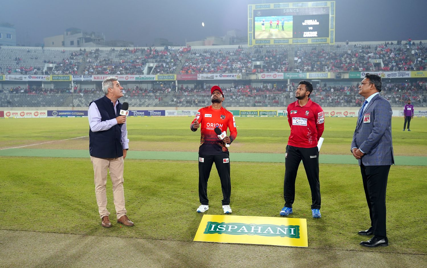 Imryul Kayes spins the coin as Shakib Al Hasan watches
