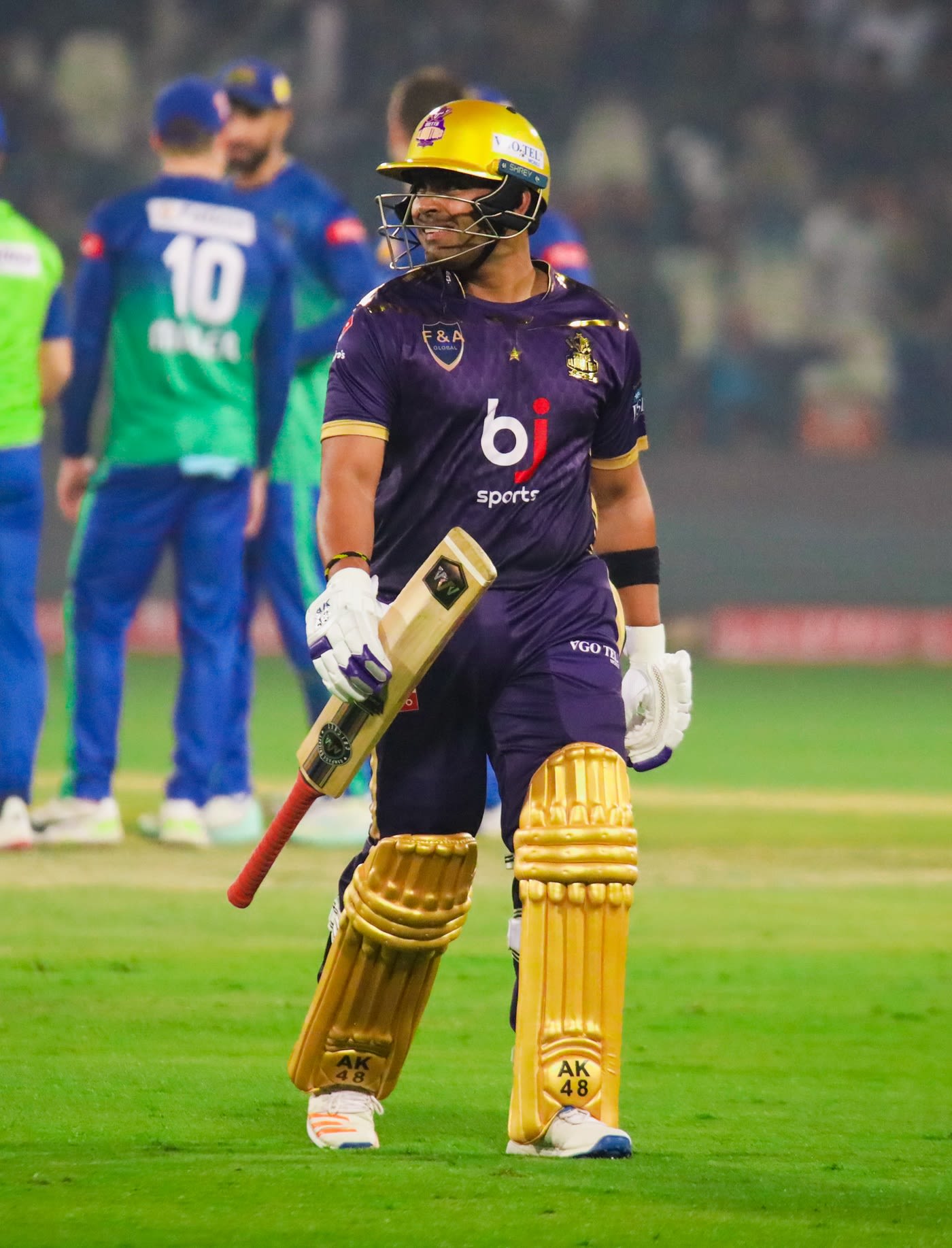 Umar Akmal walks back after being dismissed