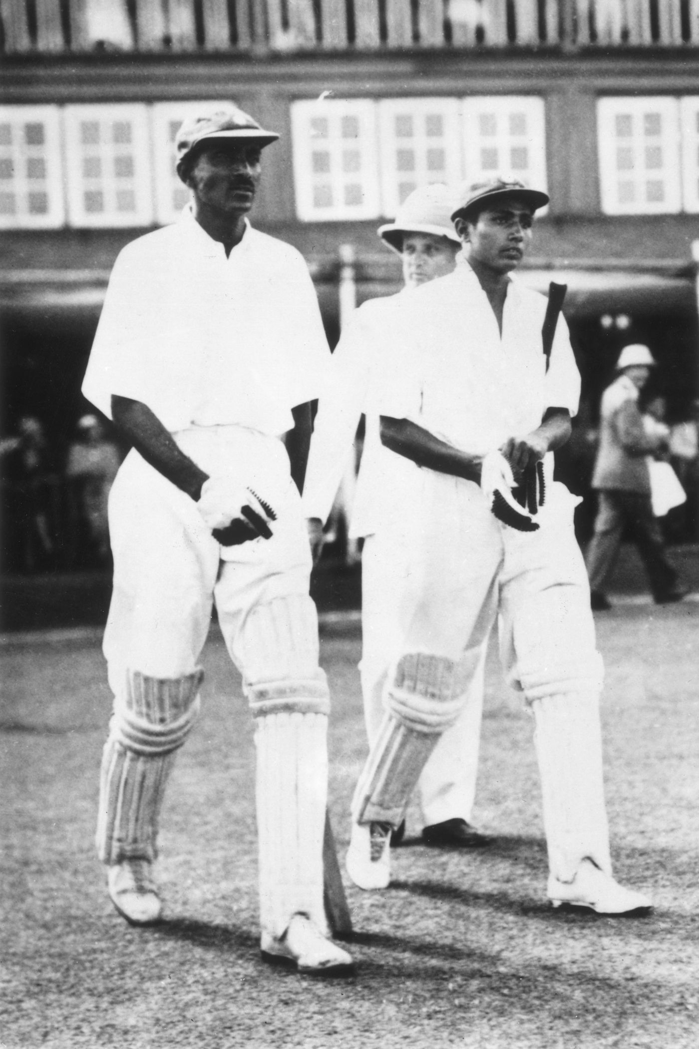 CK Nayudu and Lala Amarnath walk out to bat in India's first home Test