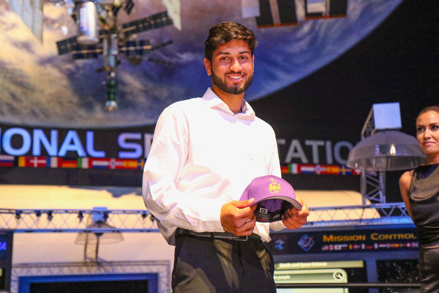 Ali Sheikh accepts his LA Knight Riders cap after being taken in the sixth round of the MLC Draft