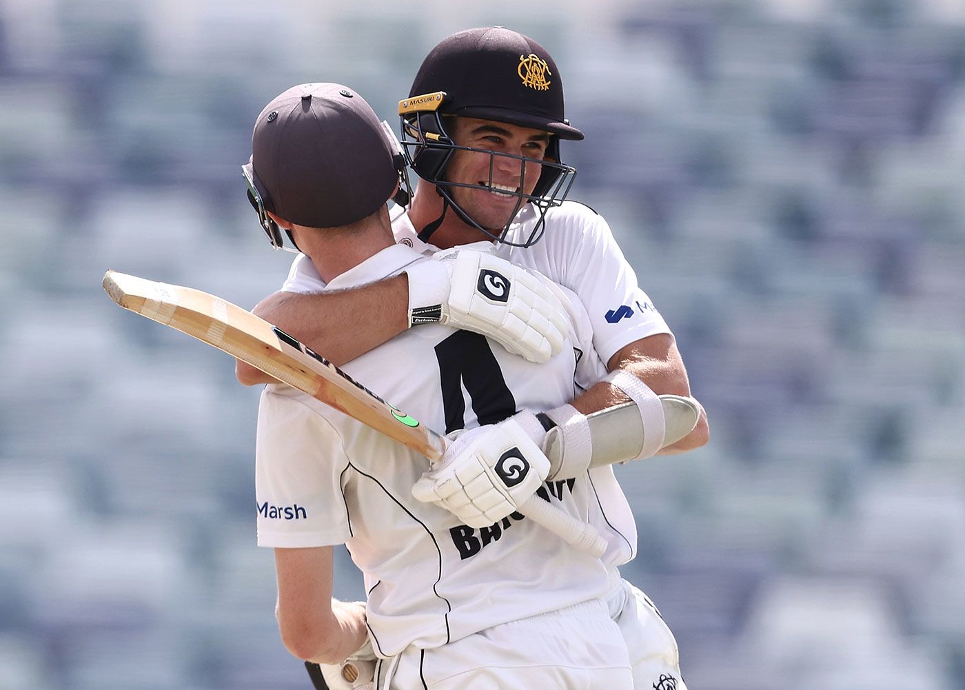 Teague Wyllie and Cameron Bancroft embrace after the winning runs