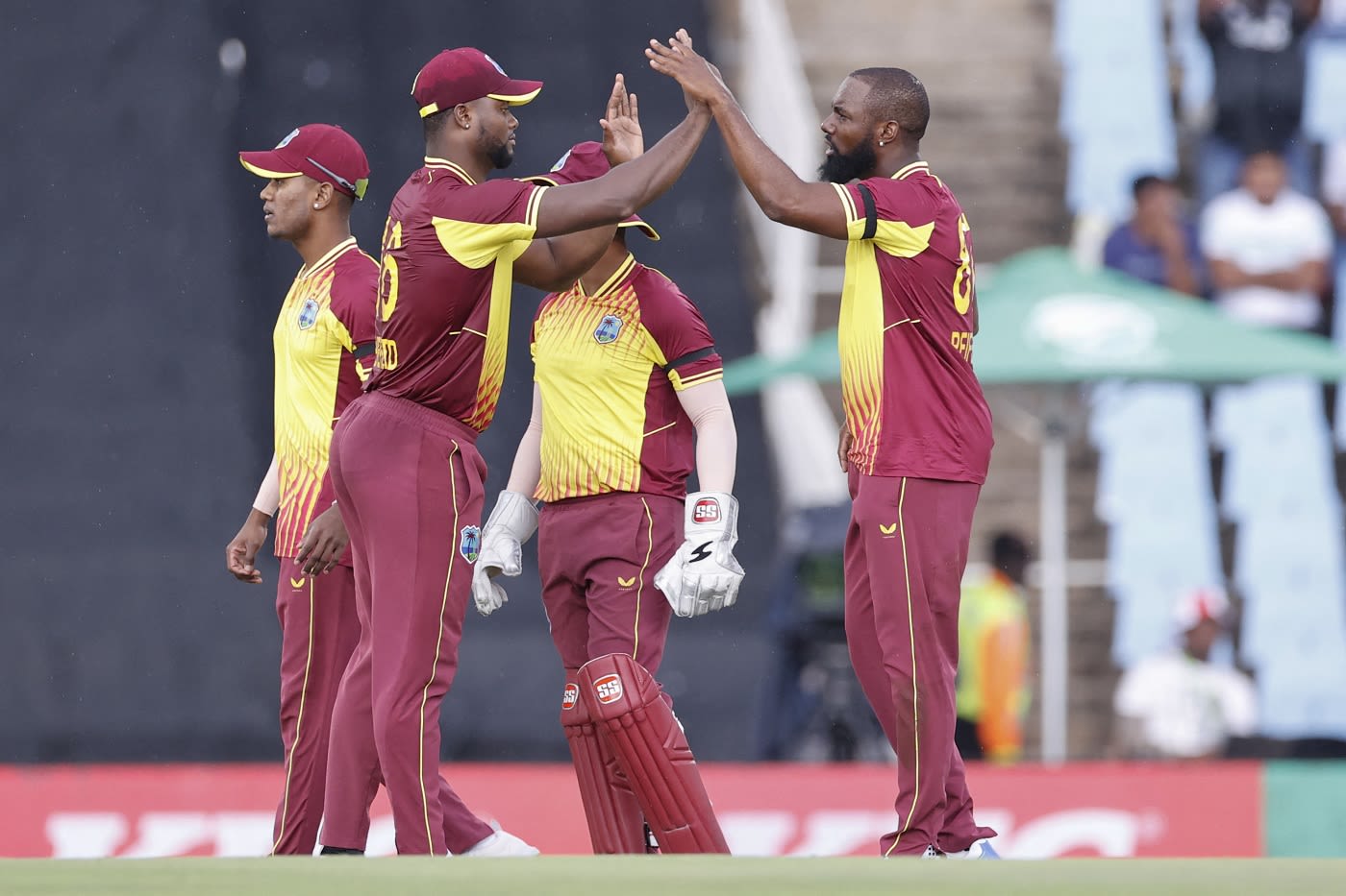 Raymon Reifer celebrates the wicket of Quinton de Kock with Romario Shepherd