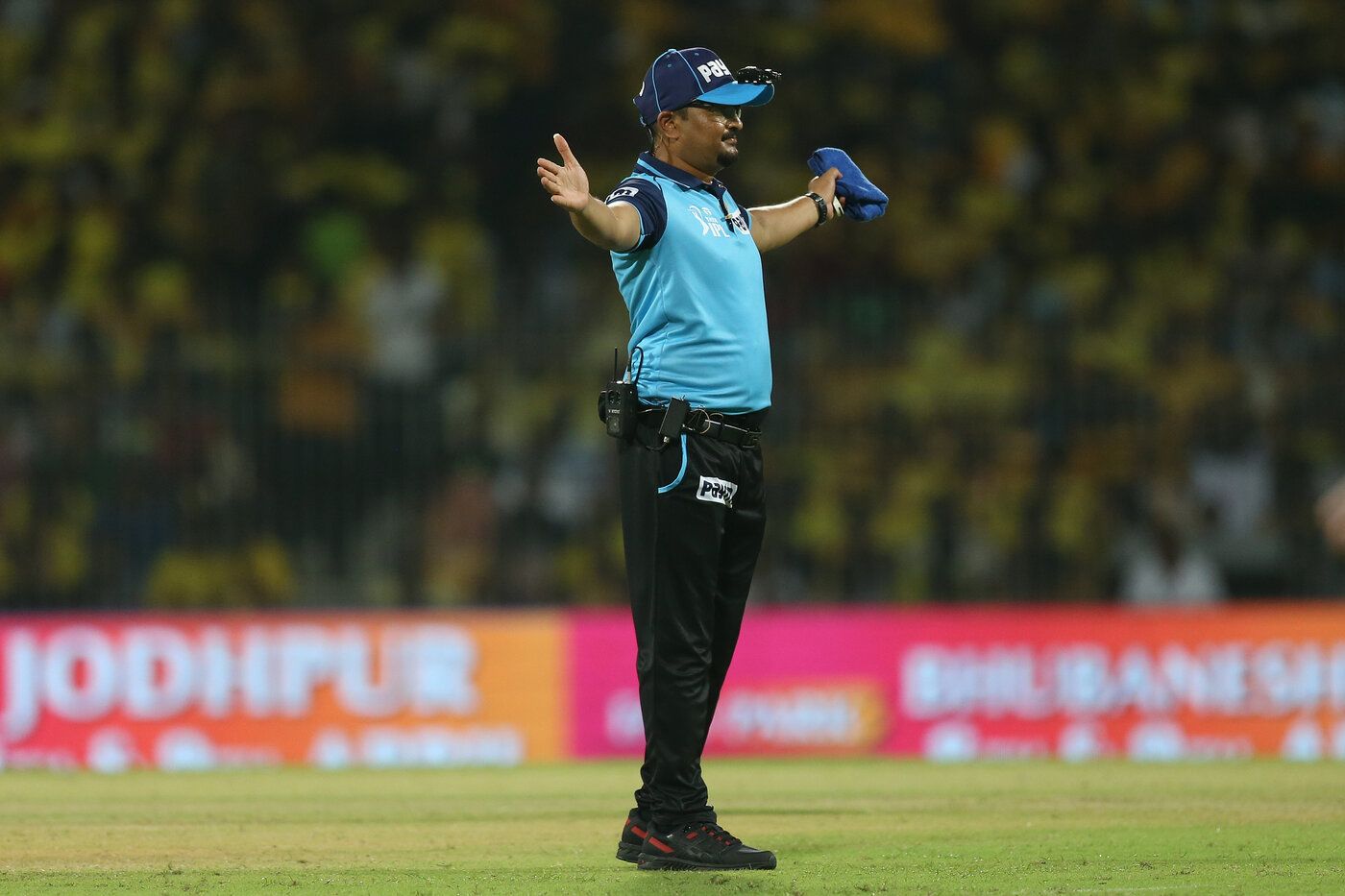Umpire Akshay Totre signals a wide