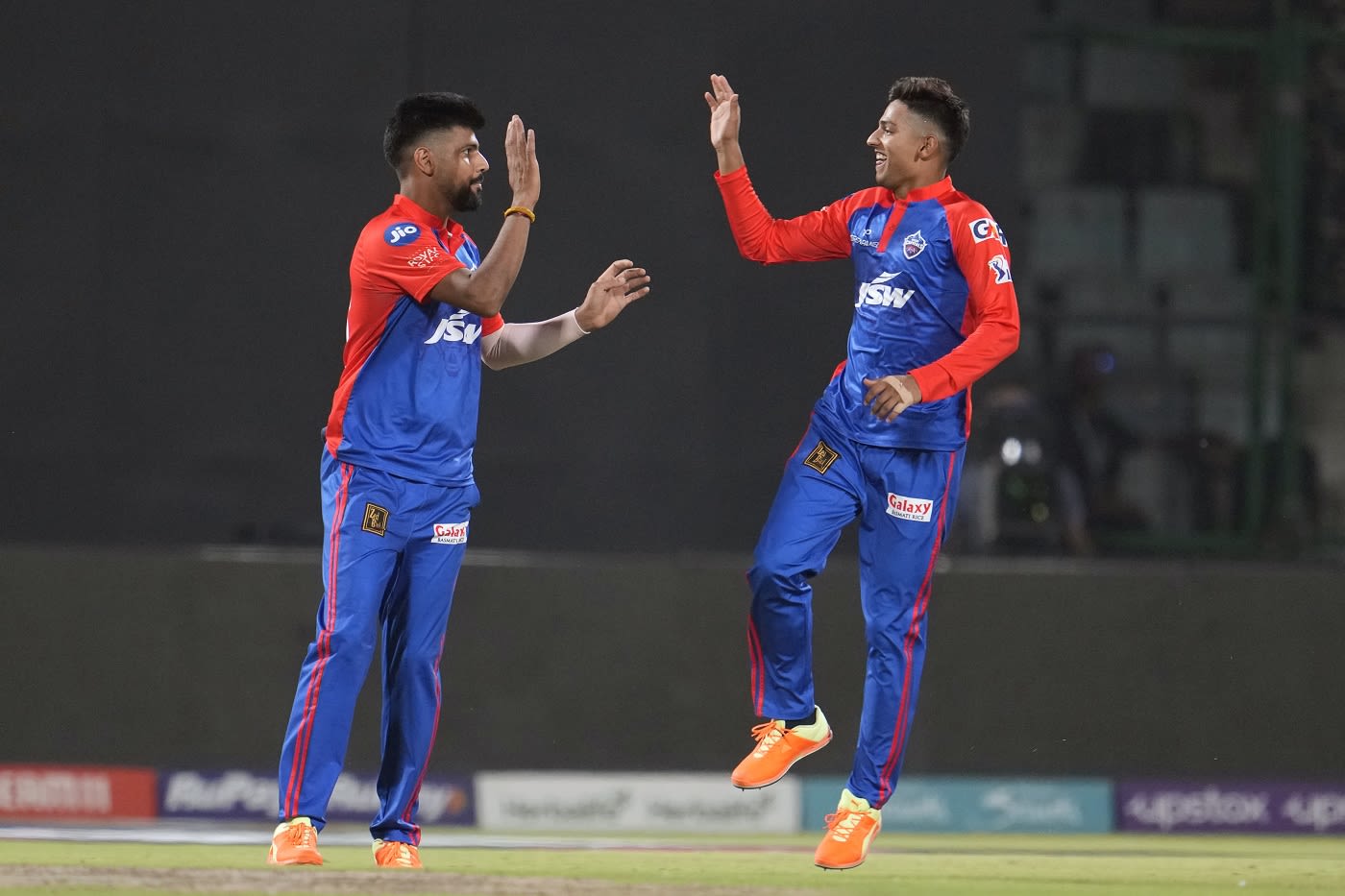Lalit Yadav and Yash Dhull celebrate a wicket
