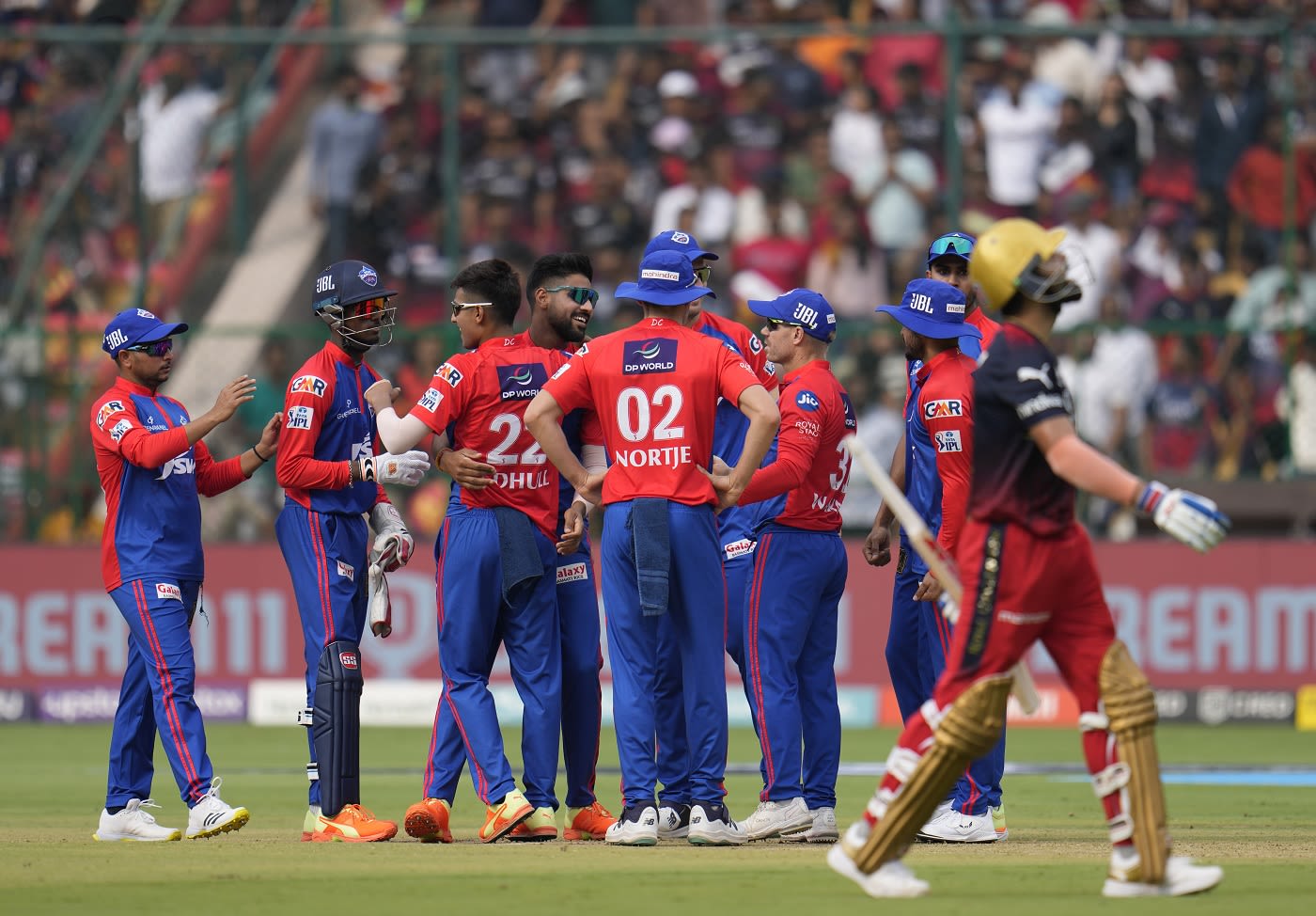 Lalit Yadav celebrates his wicket as Virat Kohli walks off