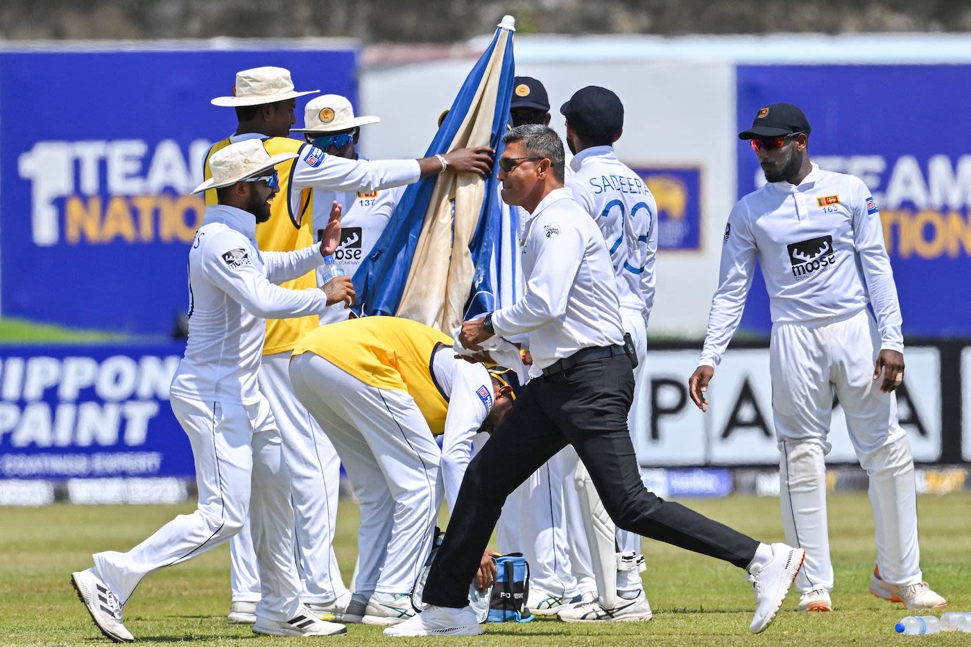 Kusal Mendis shares a lighthearted moment with Umpire Ruchira Palliyaguruge