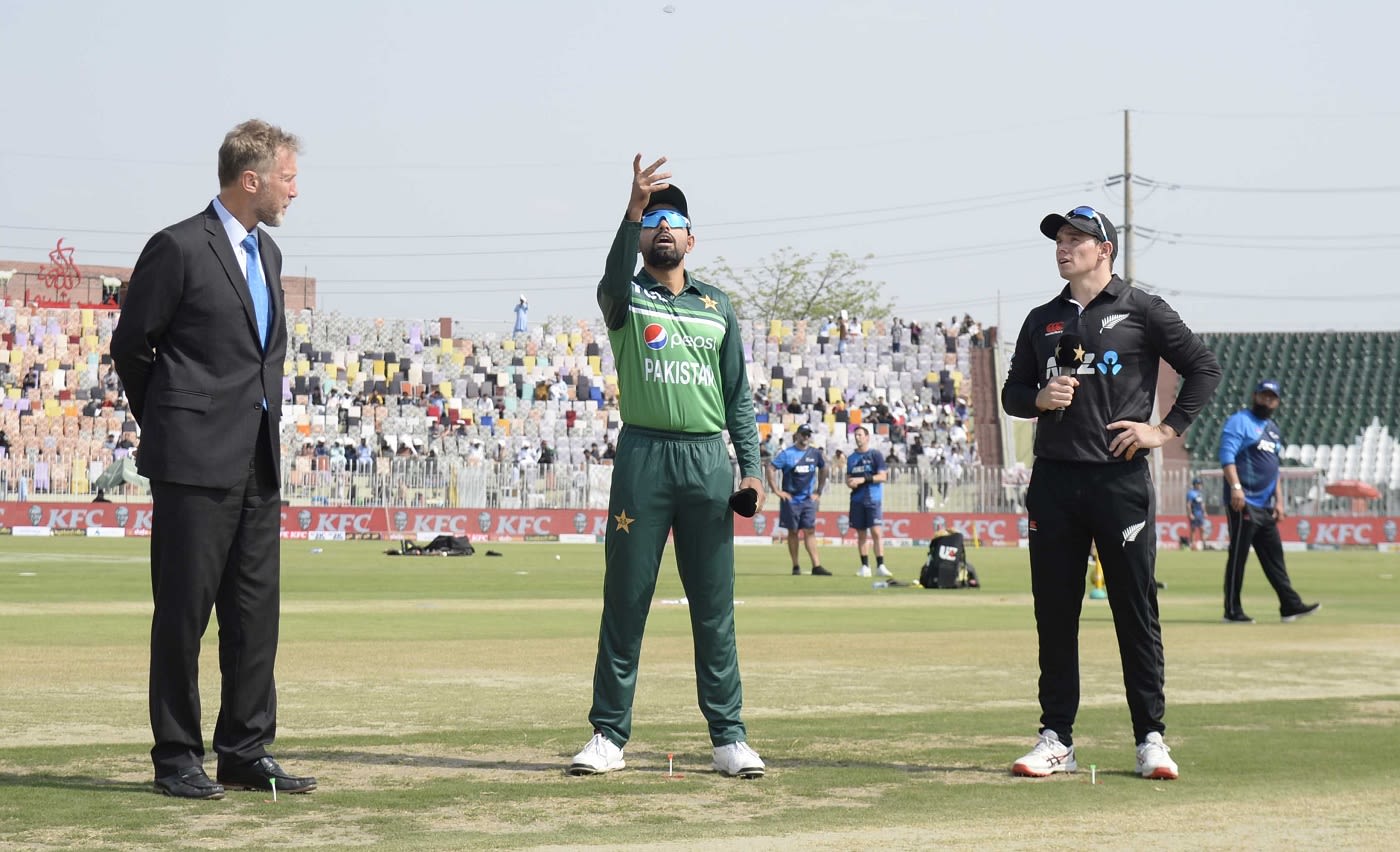 Babar Azam spins the coin as Tom Latham and Chris Broad look on