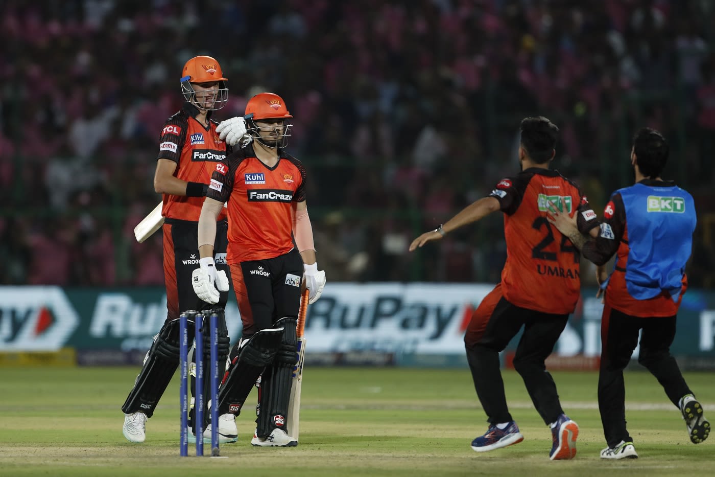 Abdul Samad is mobbed by his team-mates after hitting the winning six