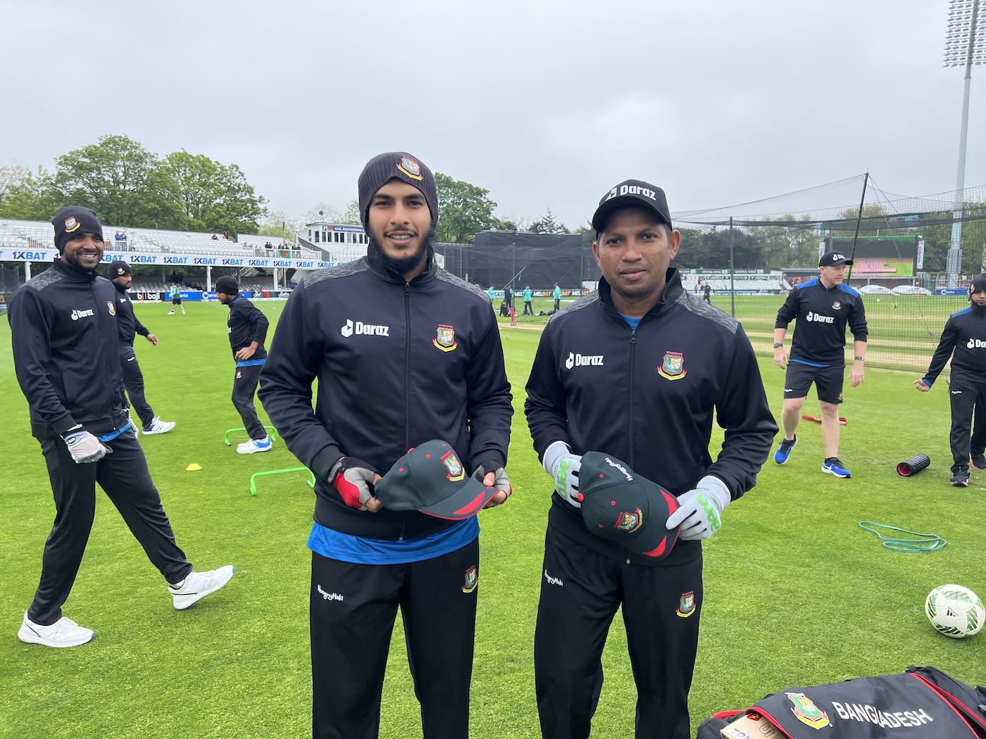 Mrittunjoy Chowdhury and Rony Talukdar pose with their caps while a happy Ebadot Hossain photobombs