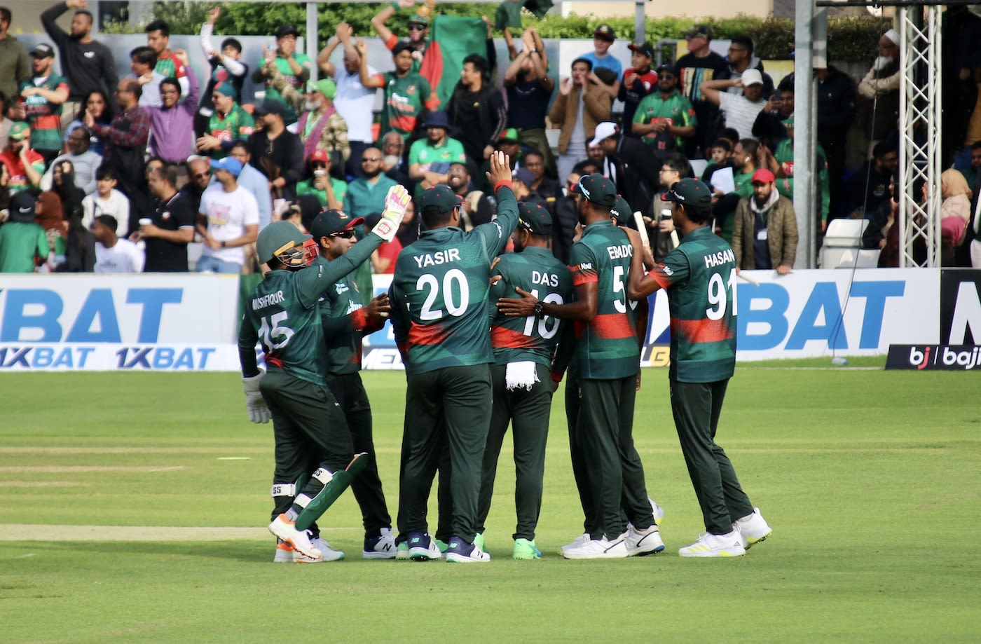 Bangladesh players congregate to celebrate a wicket