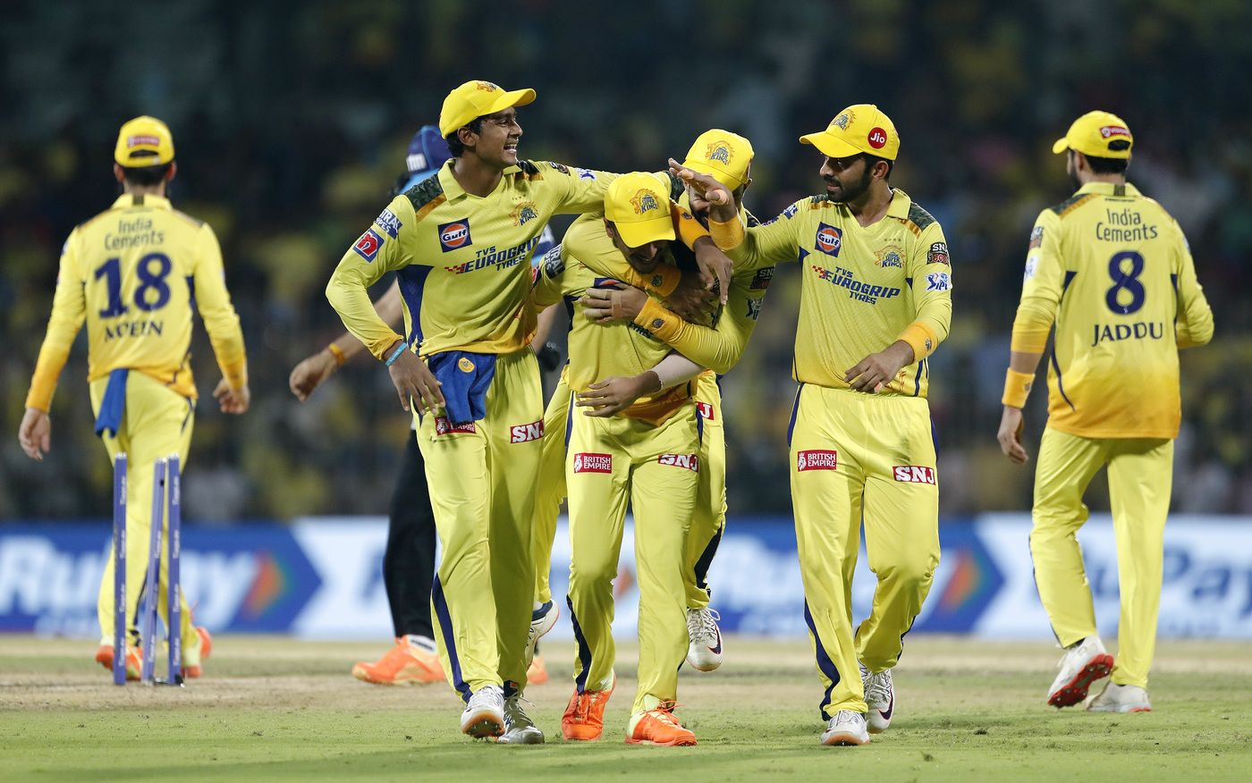 Substitute fielder SP Senapati is mobbed by team-mates after scoring a direct-hit to send back Darshan Nalkande