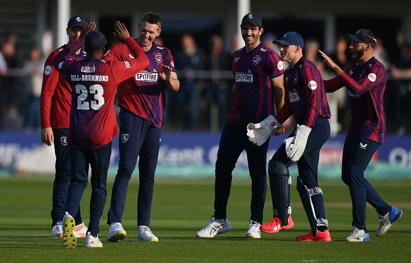 Michael Hogan celebrates with team-mates after taking the wicket of Chris Dent