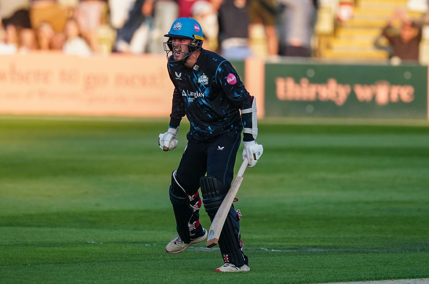 Adam Finch celebrates hitting the winning six