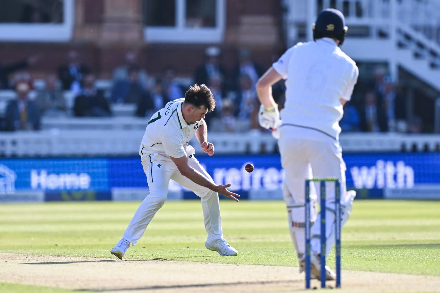 Fionn Hand takes a juggling catch to dismiss Zak Crawley for his first Test wicket