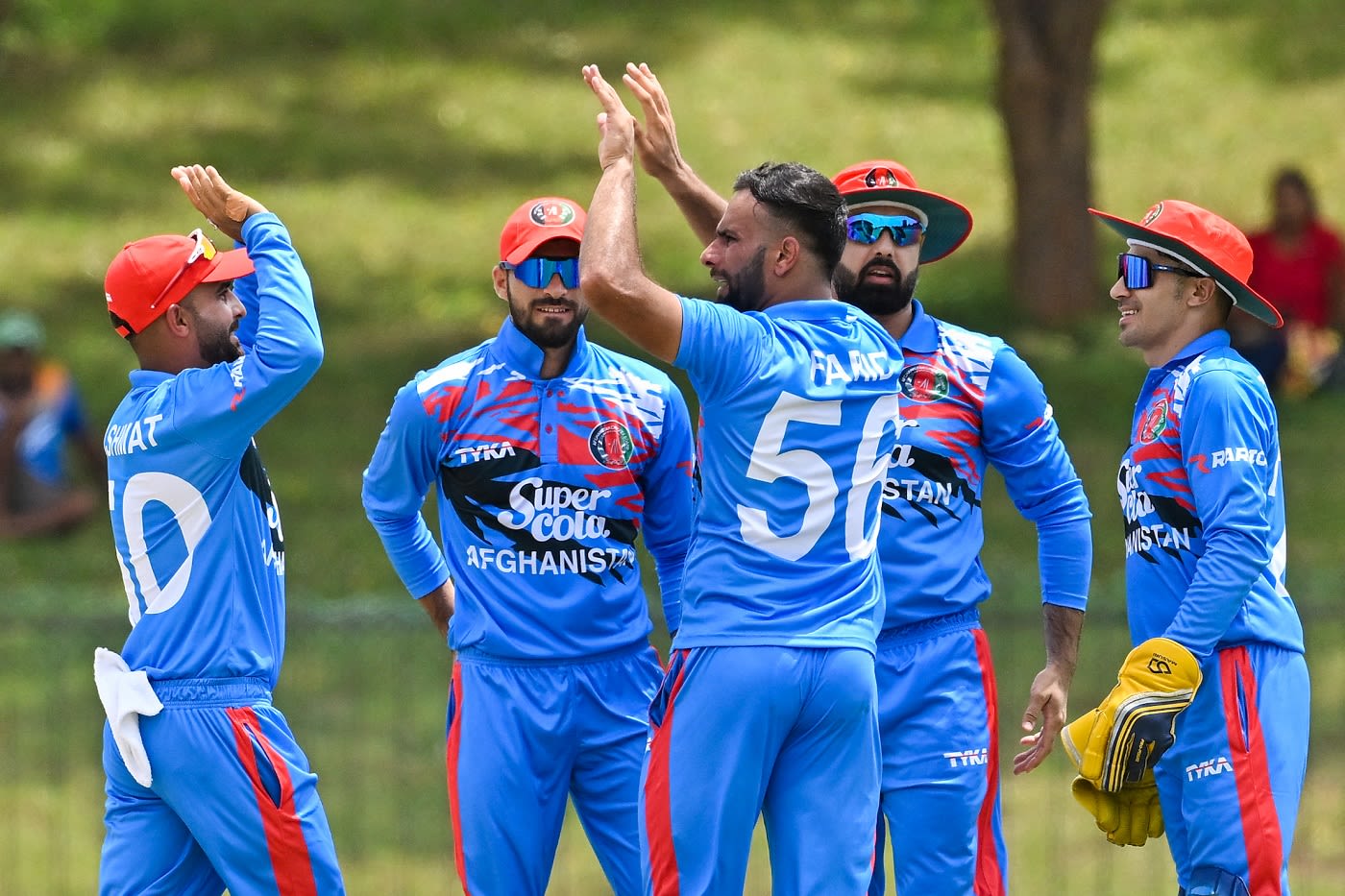 Fareed Ahmad celebrates with team-mates