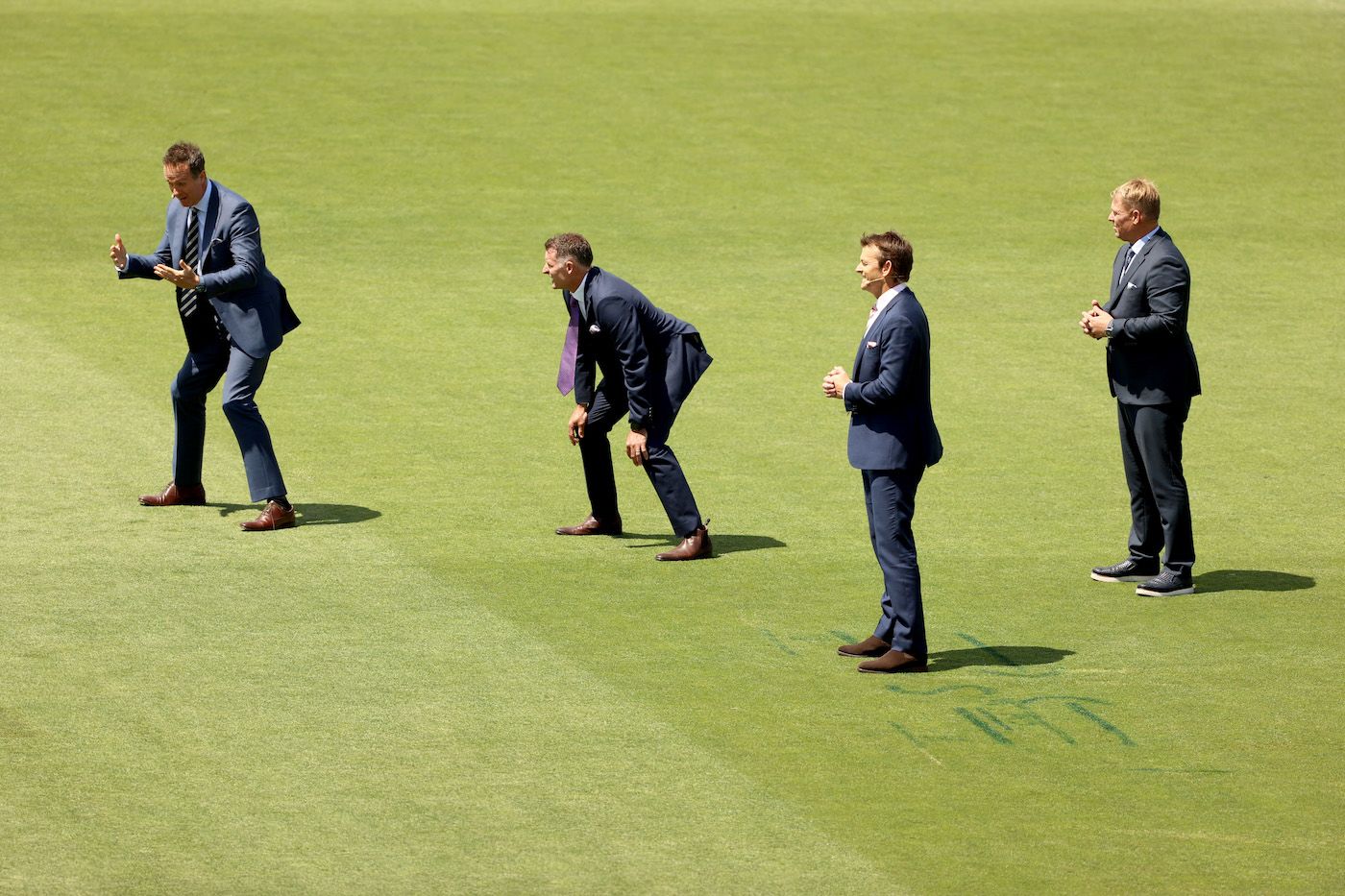 Commentators film a TV segment standing in slips