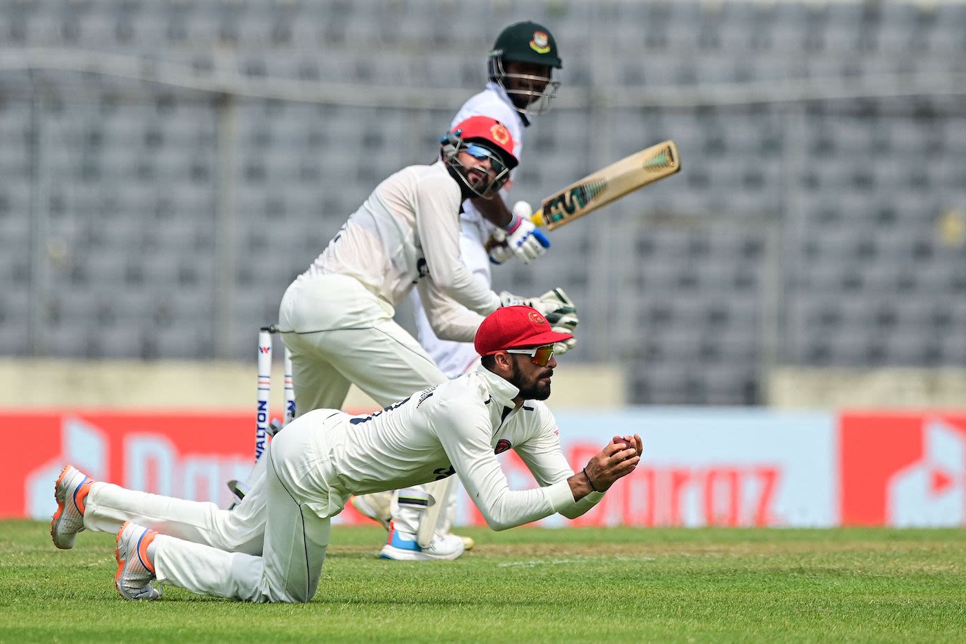 Ibrahim Zadran takes a sharp catch at slip to end Mahmudul Hasan Joy's 76