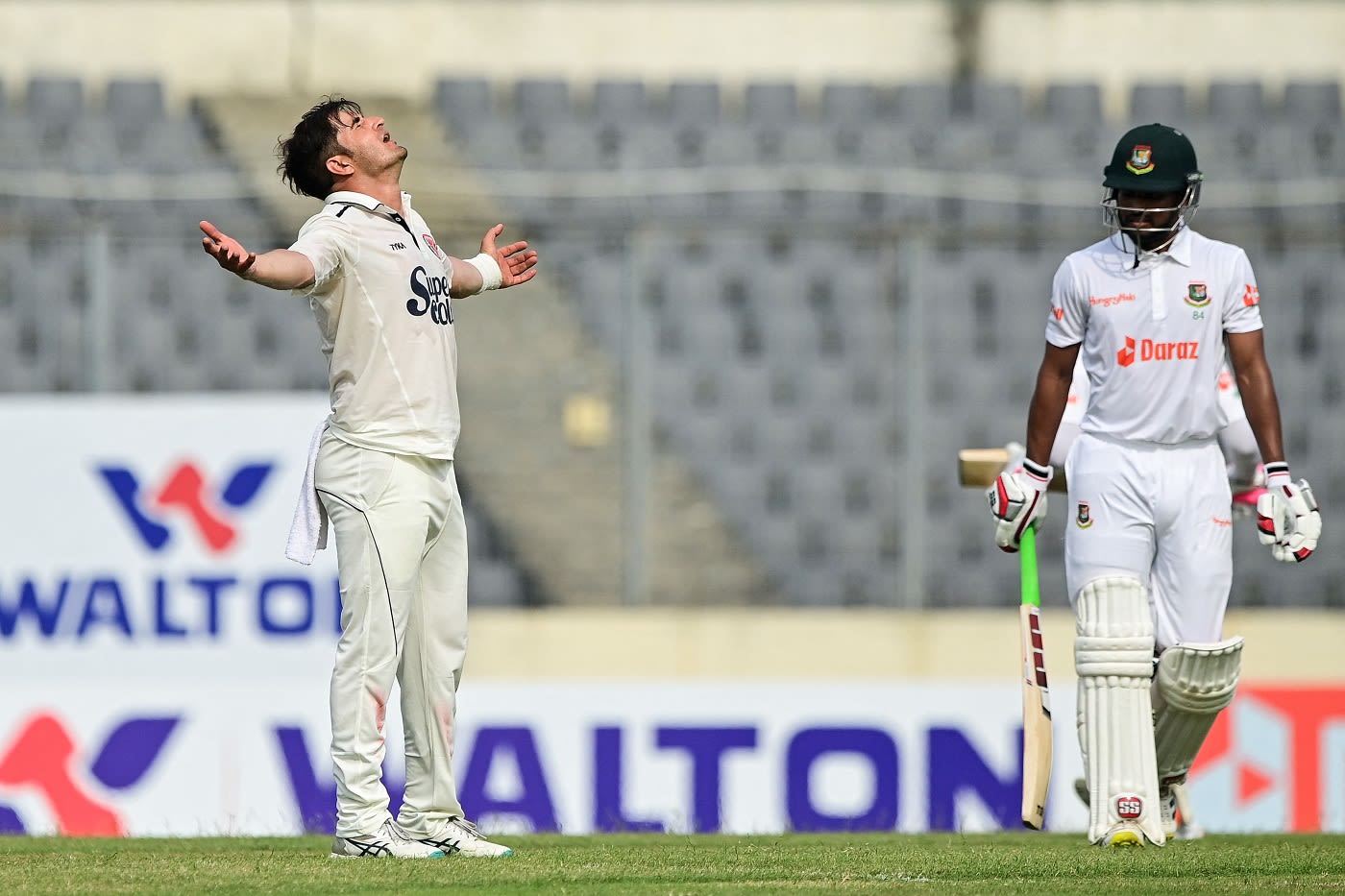 Amir Hamza soaks it in while Najmul Hossain Shanto walks back