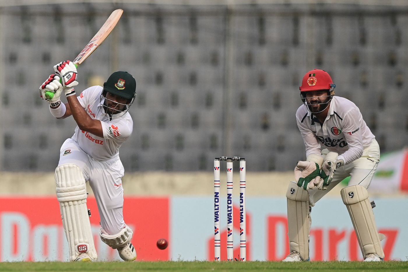Zakir Hasan drives as Afsar Zazai watches