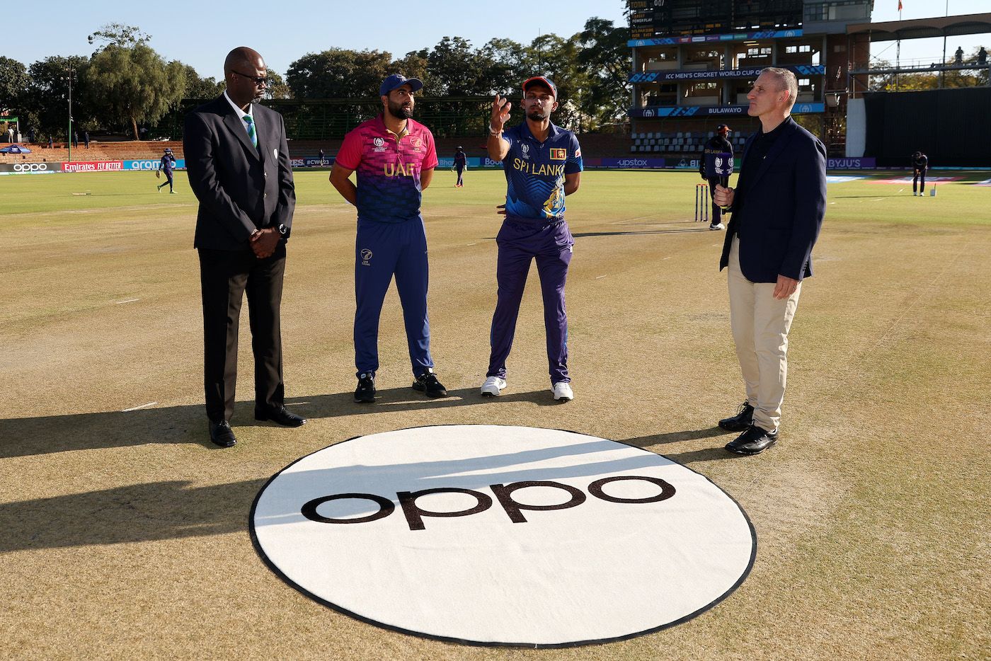 Captains Muhammad Waseem and Dasun Shanaka with Match Referee Emmanuel Dube at the toss