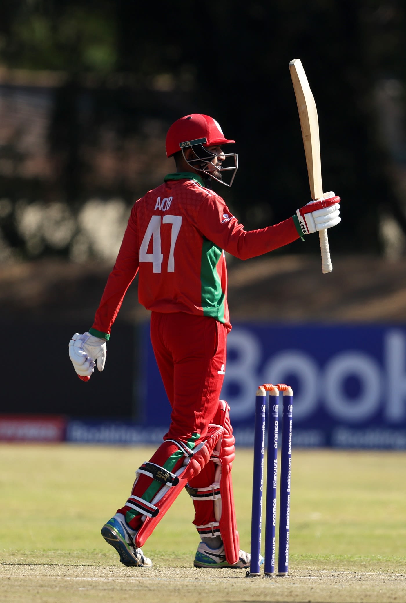 Aqib Ilyas raises his bat after reaching a fine half-century