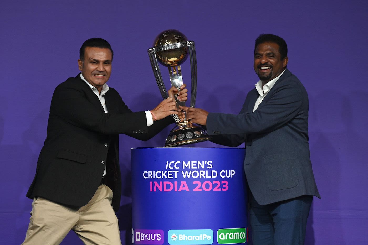 Virender Sehwag and Muthiah Muralidaran, both former ODI World Cup winners, mock tussle with the trophy at an event in Mumbai