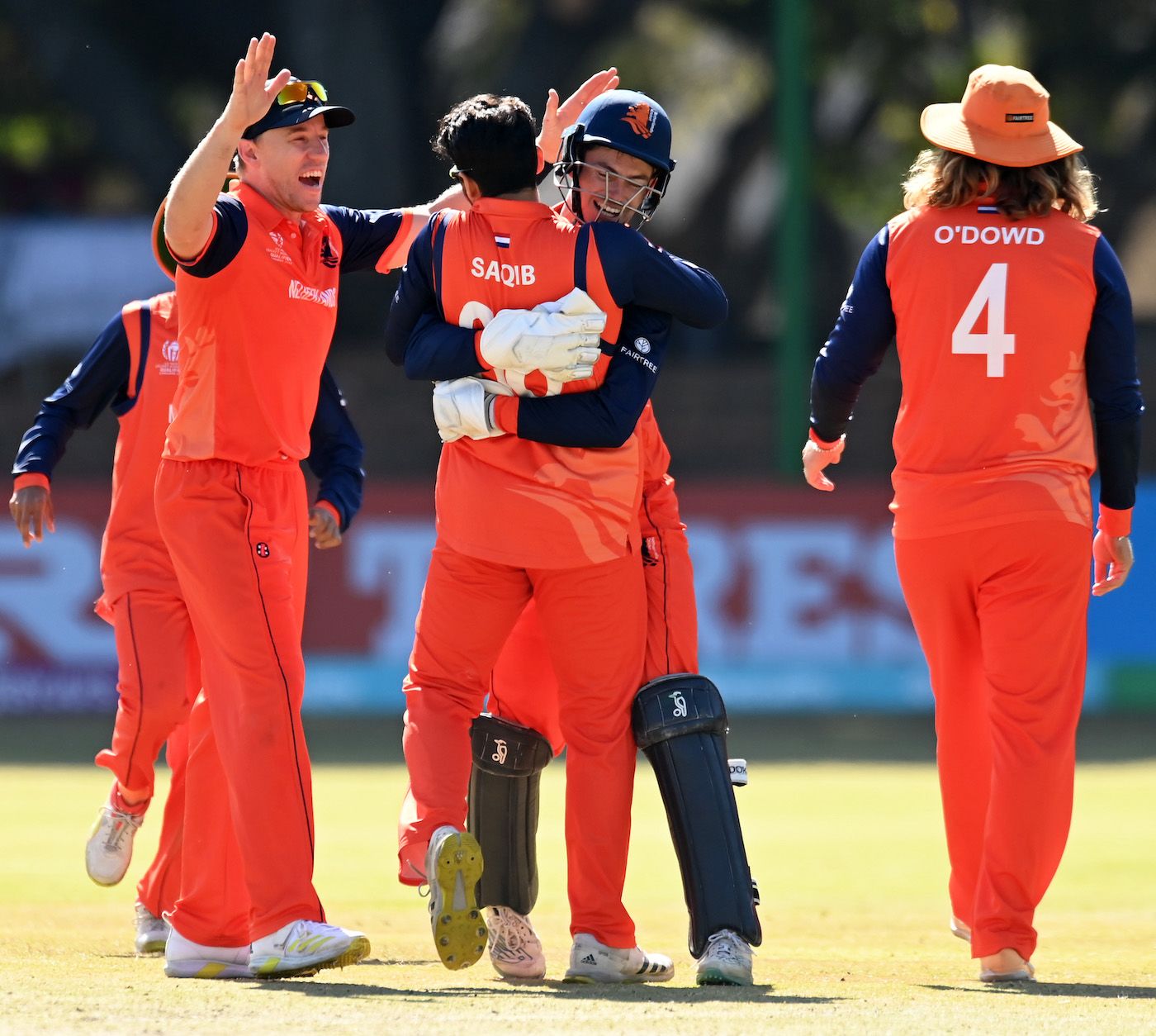 Scott Edwards and Saqib Zulfiqar celebrate after combining to send back Dimuth Karunaratne